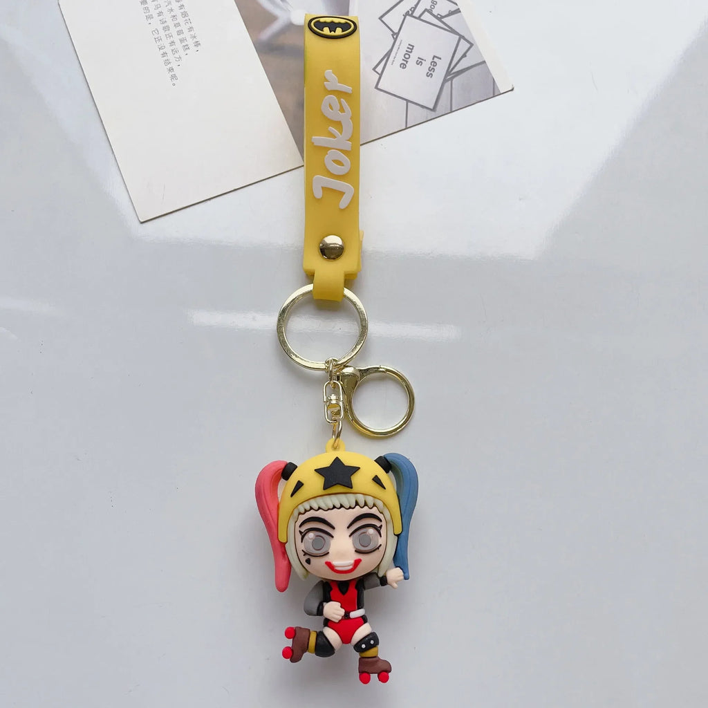 Cartoon-style girl character PVC keychain with yellow strap on white background
