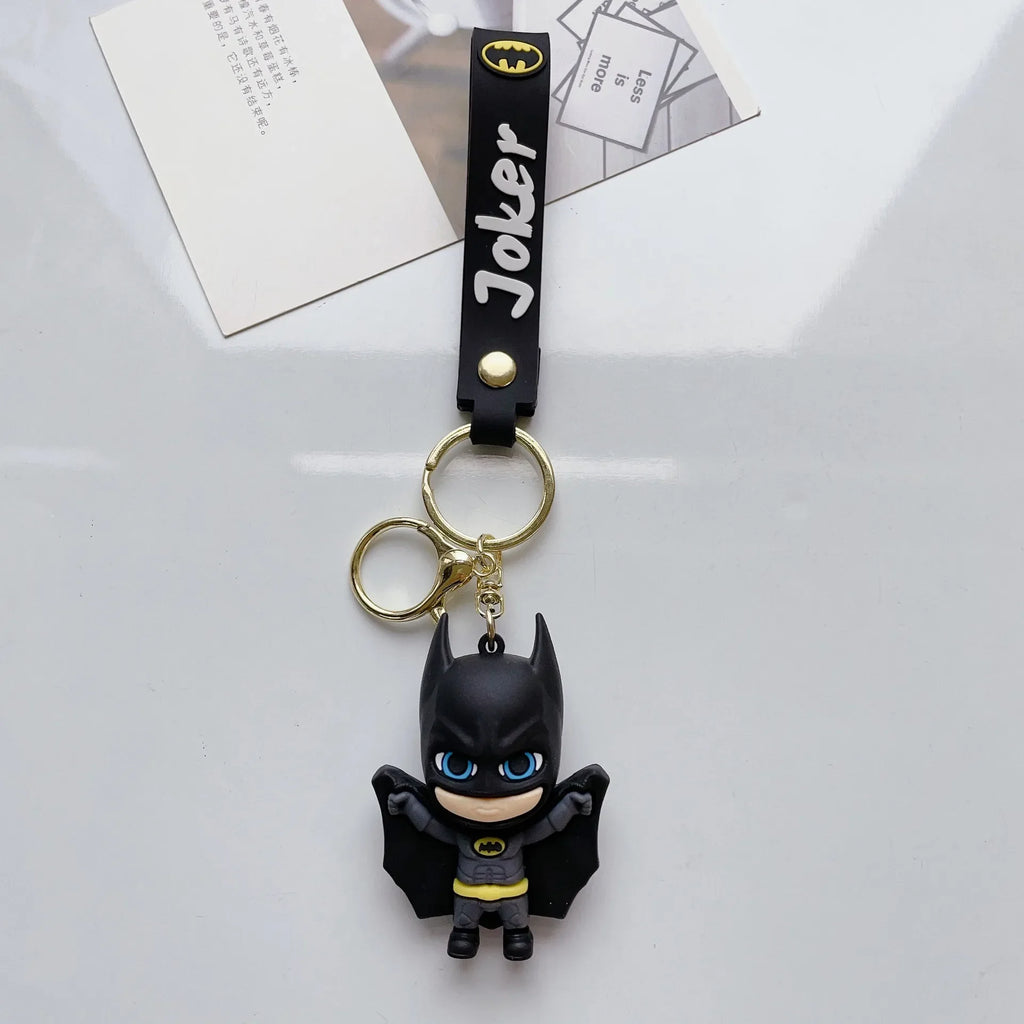Cartoon-style hero-inspired PVC keychain with black strap on white background