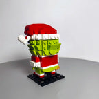 Side back angle of Christmas Green Monster MOC building blocks model with Santa hat, interlocking brick holiday figure by Toylvia