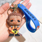 Chucky-style horror doll keychain holding chainsaw with blue strap attached