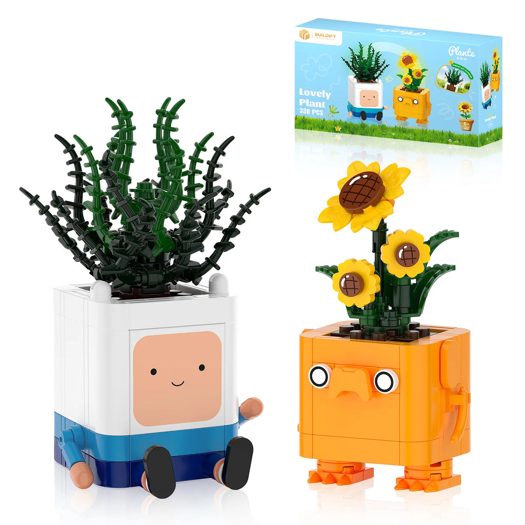 Two toy planters with faces, one green and one orange, next to a packaging box.
