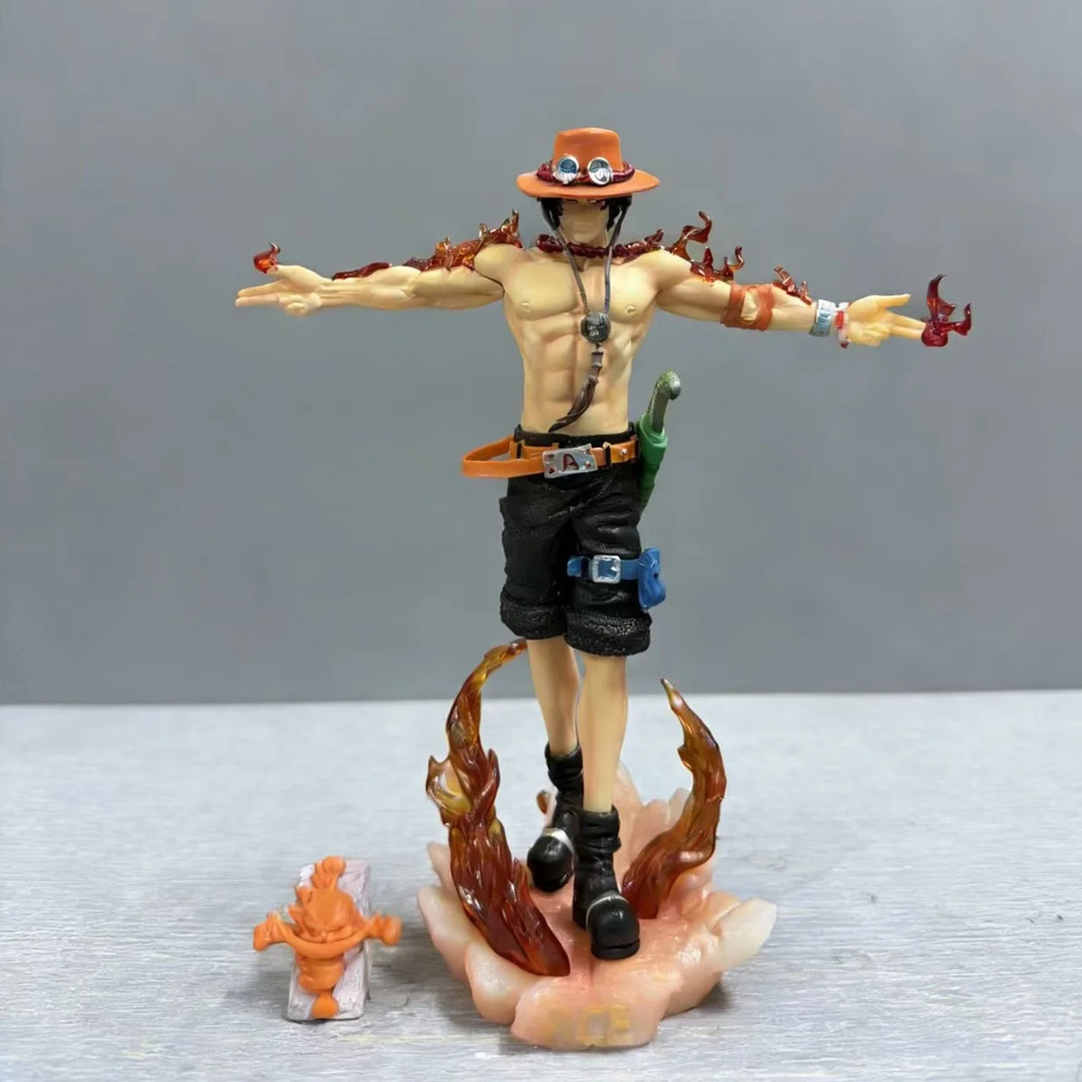 Fire Fist Ace One Piece action figure full body view with flame base, dynamic stance, and included accessory on gray background