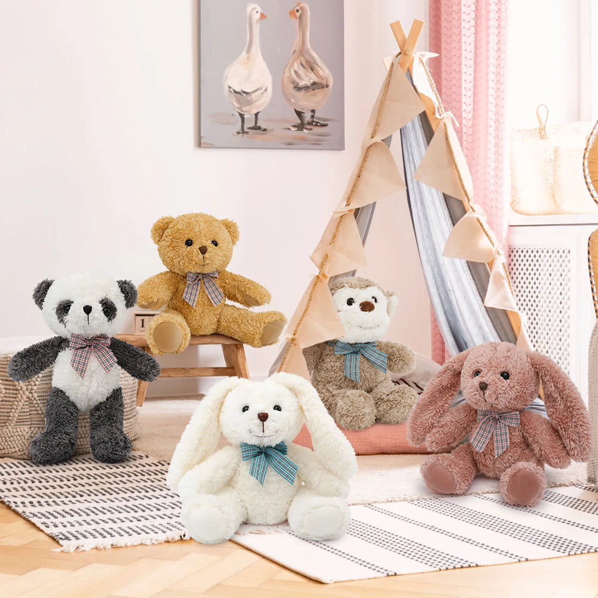 Stuffed animals with bow ties on a wooden floor in a child's room with a teepee and wall art.
