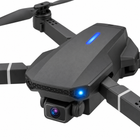 Macro detail of the folding drone’s front camera and blue status light.