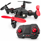 Three-quarter view of the black and red foldable nano quadcopter with its matching controller.