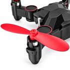 Close-up of a red propeller and motor on the black foldable nano drone.