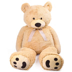 Beige teddy bear with a bow on a white background