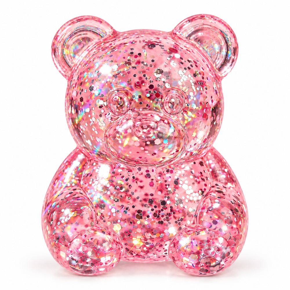Translucent pink glitter teddy-bear squishy, seated upright on white