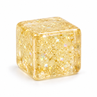 Three-quarter side view of the translucent golden glitter cube squishy fidget.