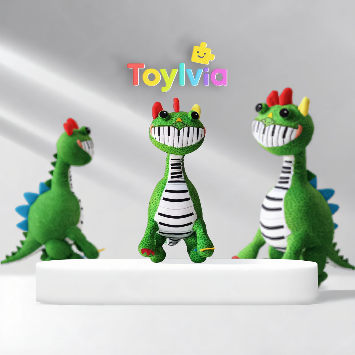 Group of Pianosaurus plush toys showing the striped keyboard belly and red head fins.