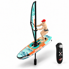 Green RC windsurfing toy boat with rider, clean three-quarter studio view on white