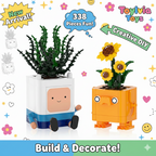 Two toy planters with faces, one green and one orange, on a colorful background with 'Toylovia Toys' branding.