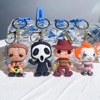 Four horror-style cartoon doll keychains in different spooky designs displayed on white surface