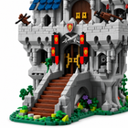 Close-up of the Lion Castle building block set front gate, drawbridge, gray masonry, blue roof, and red banners.