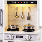 Close-up of the play kitchen hood, hanging utensils, cooktop and controls.
