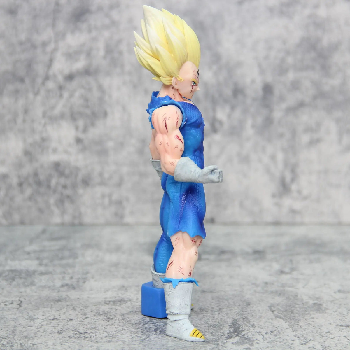 Majin Vegeta Super Saiyan action figure side profile view with spiky yellow hair and detailed sculpt on gray background