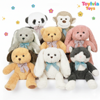 Collection of plush toys including a panda, monkey, rabbit, bear, and cat with bow ties on a white background. Brand 'Toylvia Toys' is visible.