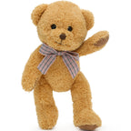 Brown teddy bear with a plaid bow tie on a white background