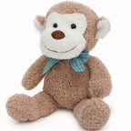 Plush monkey toy with a blue bow tie on a white background