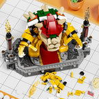 LEGO figure of a character with red and yellow outfit on a white grid surface