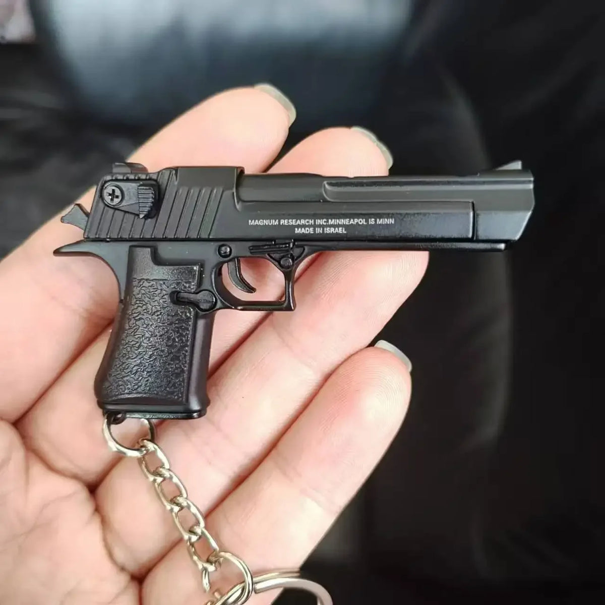 Metal 1:4 scale Desert Eagle style model keychain in black finish, alloy decorative collectible close-up