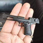Metal 1:4 scale Desert Eagle style model keychain in black finish, alloy decorative collectible shown in hand