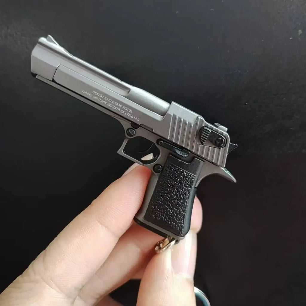 Metal 1:4 scale Desert Eagle style model keychain in grey finish, alloy decorative collectible shown in hand