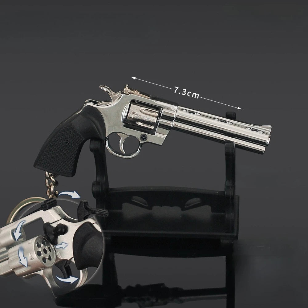 Silver alloy revolver keychain on display stand with rotating cylinder and 7.3cm size label