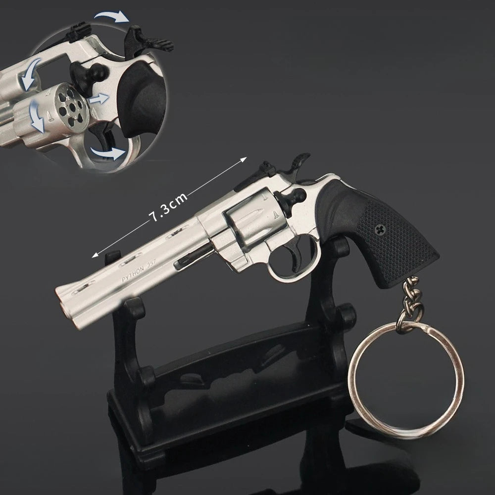 Silver alloy revolver keychain on display stand with rotating cylinder and 7.3cm size label