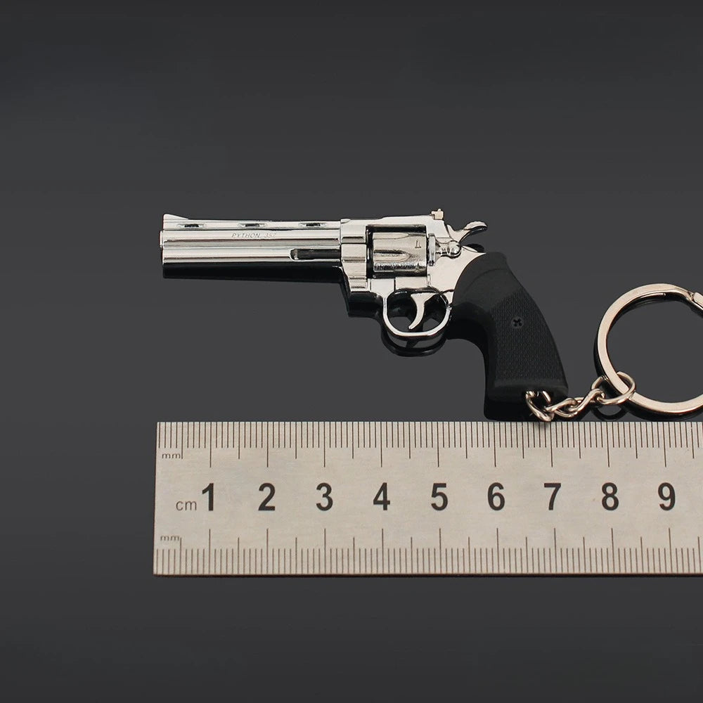 Silver alloy revolver keychain with ruler showing 7cm size measurement