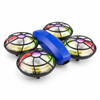 Elevated rear three-quarter view of the blue mini camera drone with four transparent illuminated rotor guards.
