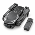 Folded dark gray shark-shaped quadcopter shown with a matching modular flight battery.