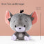 Gray plush toy with pink ears and black accents on a beige background