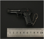 Black gun-shaped keychain with 'Pietro Beretta' branding on a dark background, accompanied by a ruler for scale.