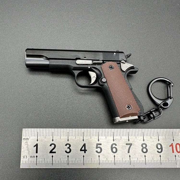 Handgun with brown grip and black metal parts on a gray background, next to a ruler for scale.