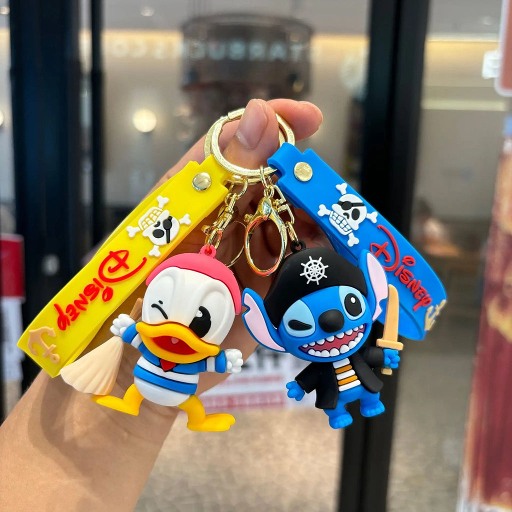 Cute pirate cartoon keychains showing a duck sailor and blue alien character with keyring straps
