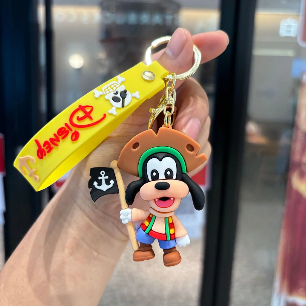 Pirate dog cartoon PVC keychain with flag detail and wrist strap, held in hand