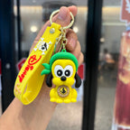 Pirate dog cartoon PVC keychain with green hat and yellow wrist strap, held in hand