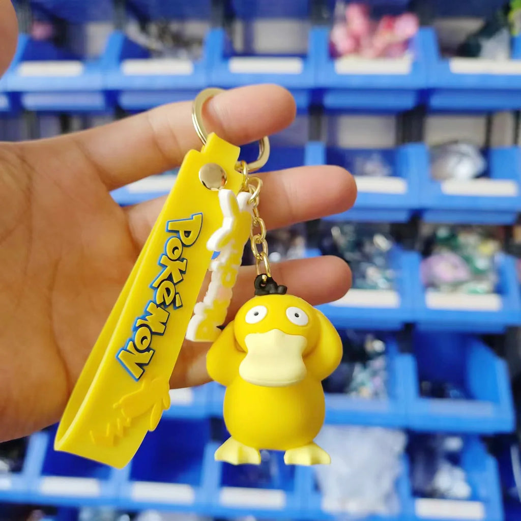 Psyduck Pokémon plush keychain hanger with yellow strap held in hand