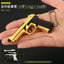 Gold and black toy gun held in a hand with text on a dark background