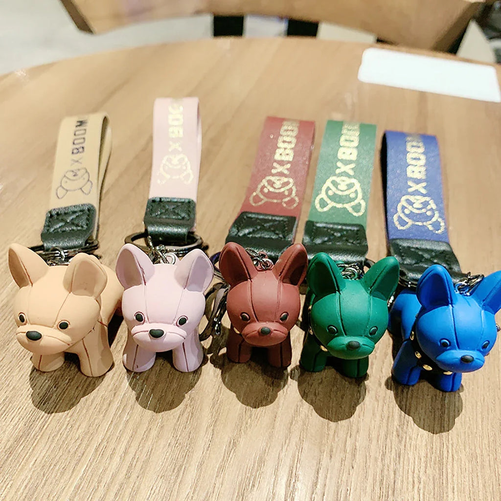 Punk French bulldog keychain color options lineup with PU leather straps on wooden surface