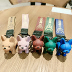 Punk French bulldog keychain color options lineup with PU leather straps on wooden surface