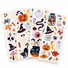 Four Halloween temporary tattoo sheets fanned out, pumpkins, ghosts, witch hats and skulls