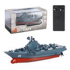 Toy warship with remote control and packaging on a white background