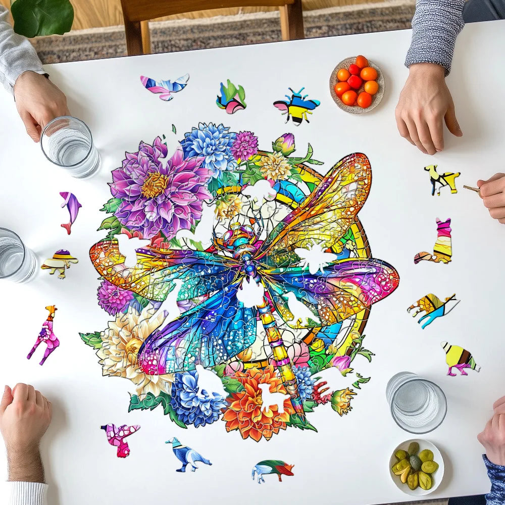Colorful puzzle with a butterfly design on a table, surrounded by hands and small dishes.