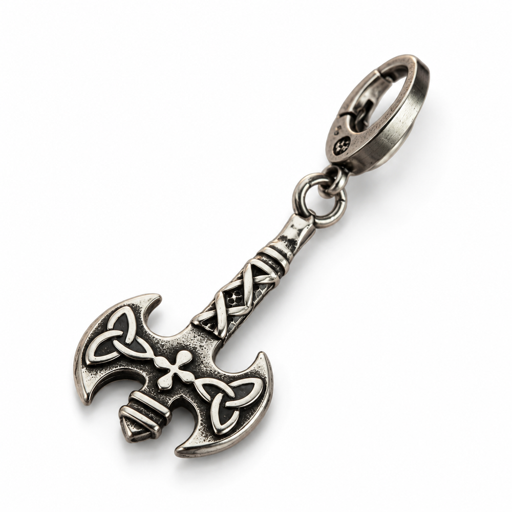 Antique silver double-headed axe pendant keychain with spring clasp, lying on white surface