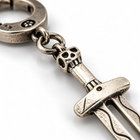 Close-up of the skull pommel and crossguard on the retro skull holy sword keychain