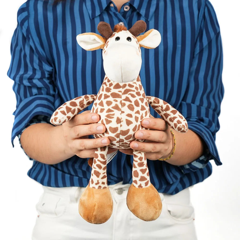 Person holding a plush giraffe toy against a blue striped shirt background