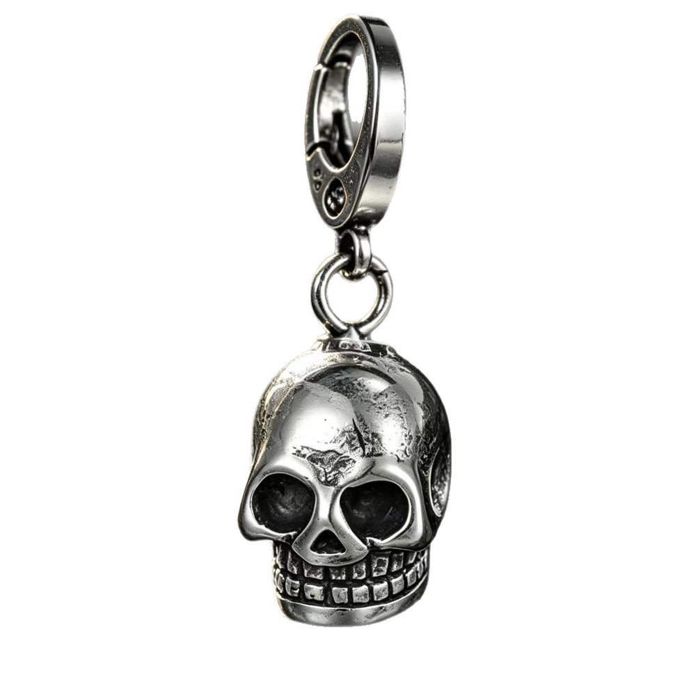 Silver stainless steel skull keychain standing upright on a clean white background showing its reflective metallic finish.