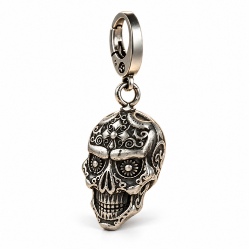 Left-facing three-quarter white studio photo of the silver skull pendant keychain, isolated with a soft contact shadow.